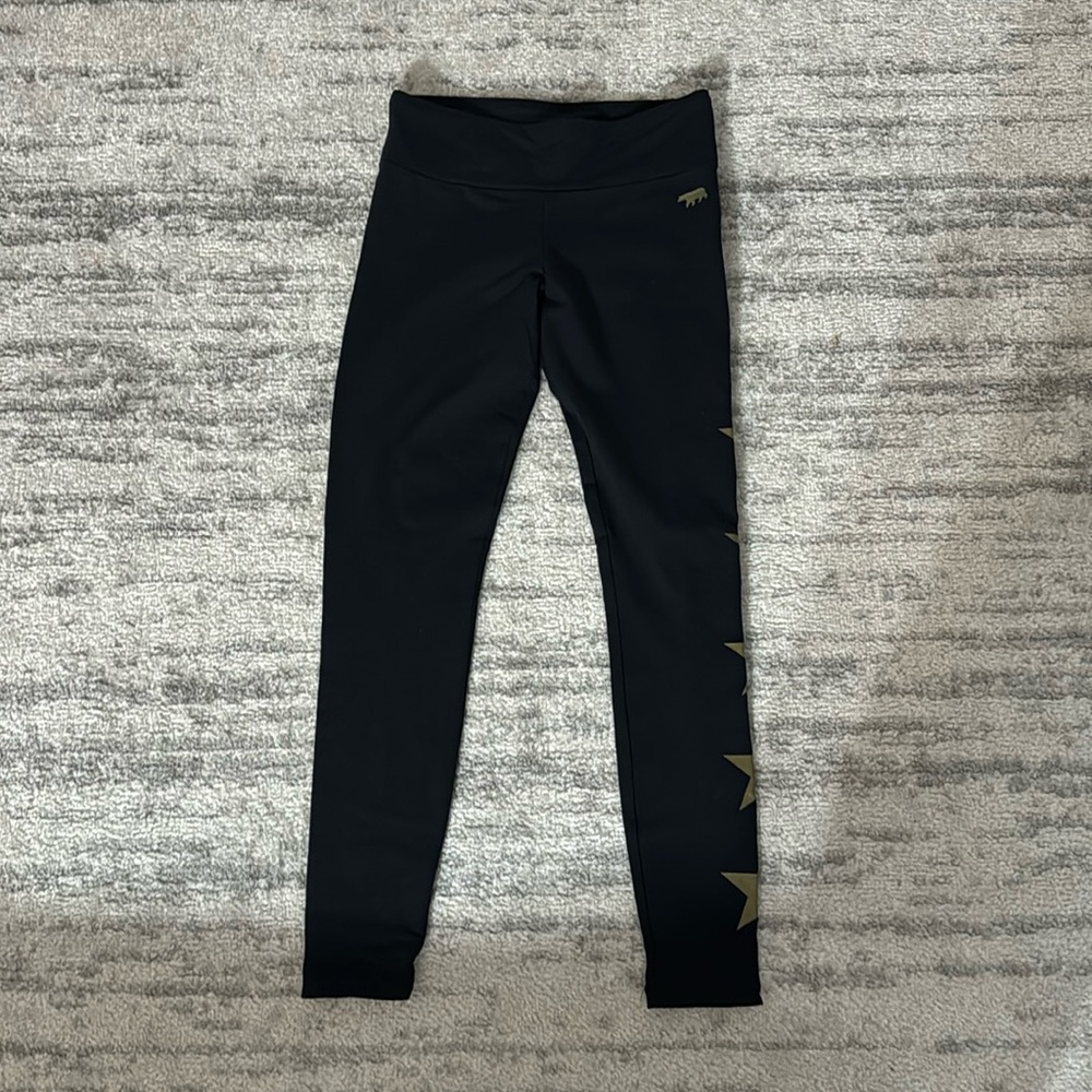 Black leggings with gold stars down one leg